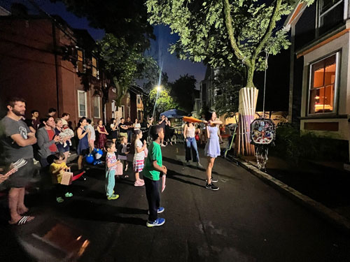 Crowd gathered at night for block party on Fairmont Avenue, Cambridge, summer 2023.