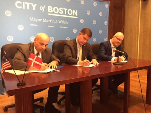 City Manager Louis A. DePasquale, Boston Mayor Martin J. Walsh, and Morten Kabell, Copenhagen Mayor of Technical and Environmental Affairs sign the Memorandum
