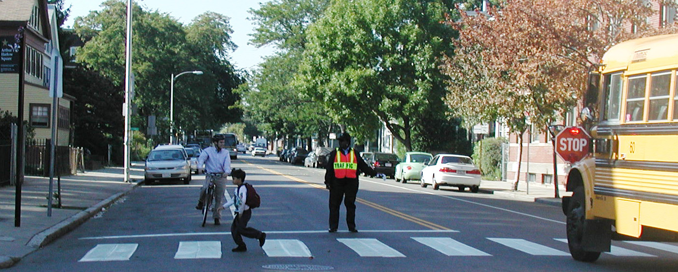 child crossing street from school bus