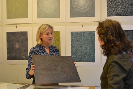 An artist speaks with an attendee at during Cambridge Open Studios.