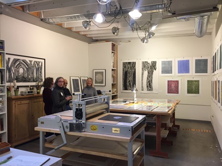 A group of artist talk in a printmaking studio in Cambridge