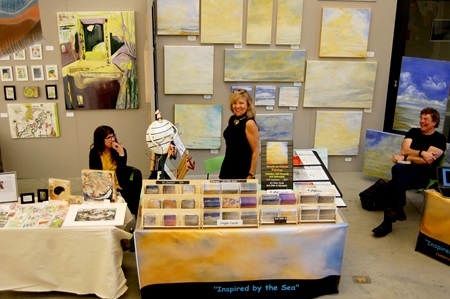 Artists Donna McNally and Hilary Tait Norod pose at their Cambridge Arts Open Studios booths