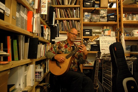 Performer Mitch Nelin plays the Mandocello at Open Studios