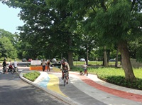 Pedestrians and cyclists enjoying the new multi-colored, multi-use path at Fern street