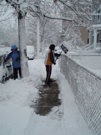 Person shoveling snow on the sidewalk