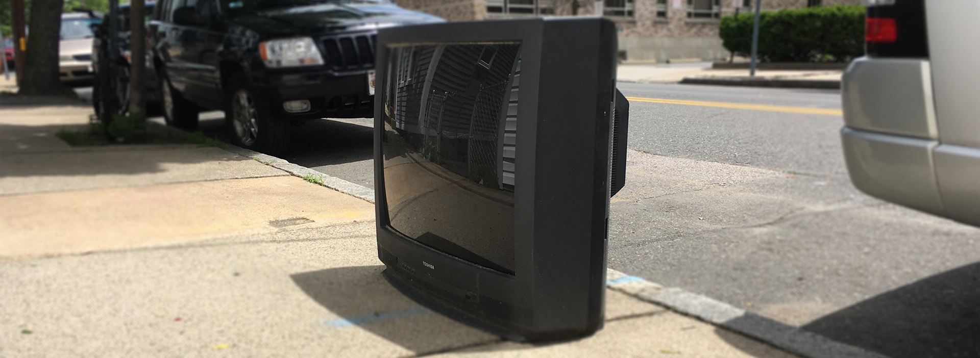 Large TV on a sidewalk