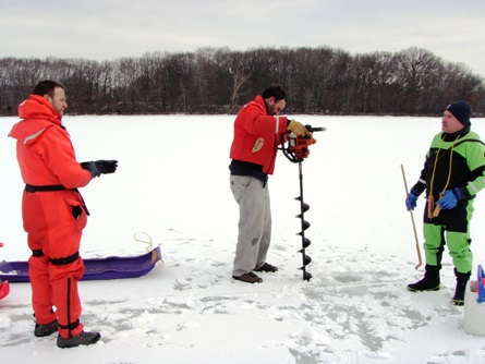 Drilling through the ice to access the water underneath for a temperature and dissolved oxygen profile.