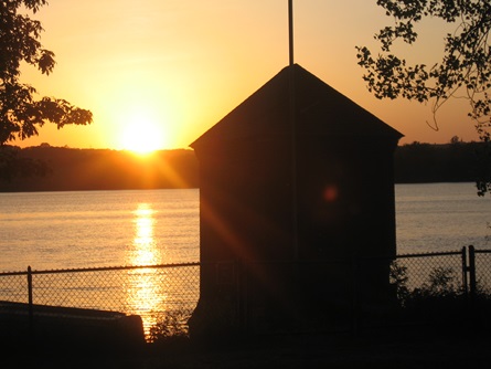 Sunset over Fresh Pond with gatehouse.