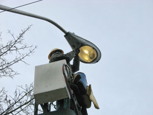 Worker repairing a street light