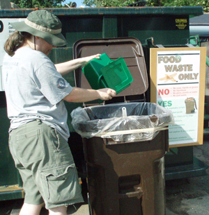 Resident dropping off food scraps at Recycling Center.