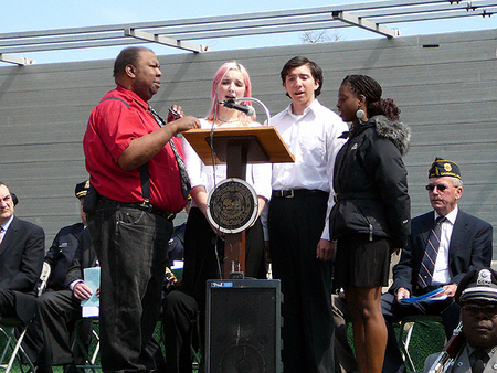 Jimmy Smith leads CRLS student vocalists Jessica Dottin-Mckie, Thomas Cohen and Kiah Mellett-Cray in singing 