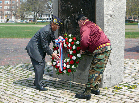 Cambridge Department of Veterans' Services Director Bob Stevens (L) places a wreath at the Washington Monument. 