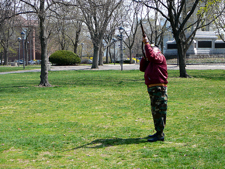 A member of the Cambridge Veterans' Organization gives the rifle salute   