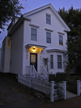 Image of a house with outdoor porch lighting. 