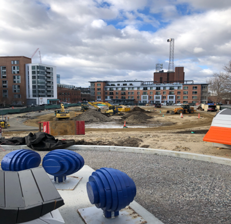 View of construction progress at Toomey Park showing play equipment on hill looking towards Third Street