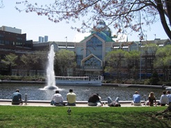 People sitting on grass at Lechmere Canal