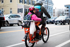 parent and child on bike