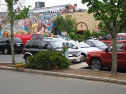 A colorful mural seen from a Central Square parking lot.
