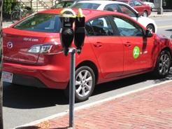 Red Zipcar parked at a meter in Cambridge, MA