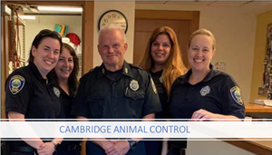 Picture of the animal control team smiling in the office.