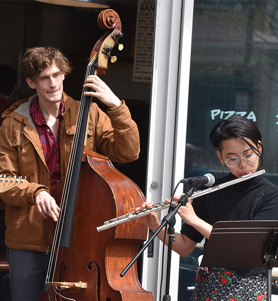 Street musicians playing flute and upright bass