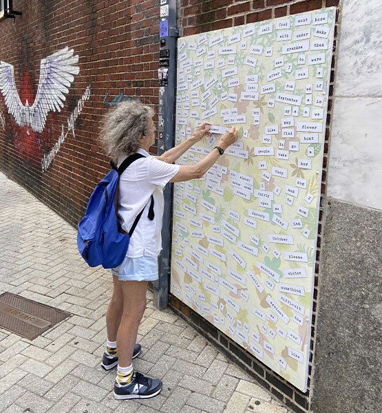 Child using the magnetic poetry wall