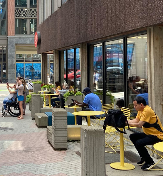 People sitting at cafe tables on Palmer St