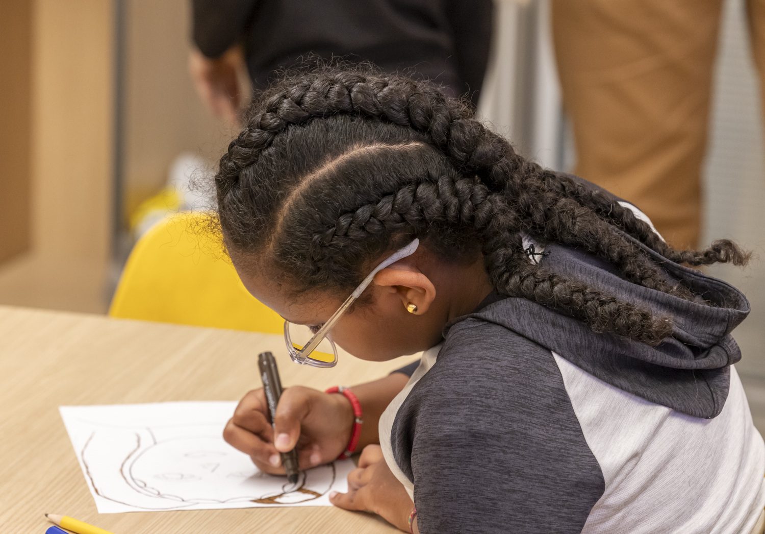 young girl writing at desk