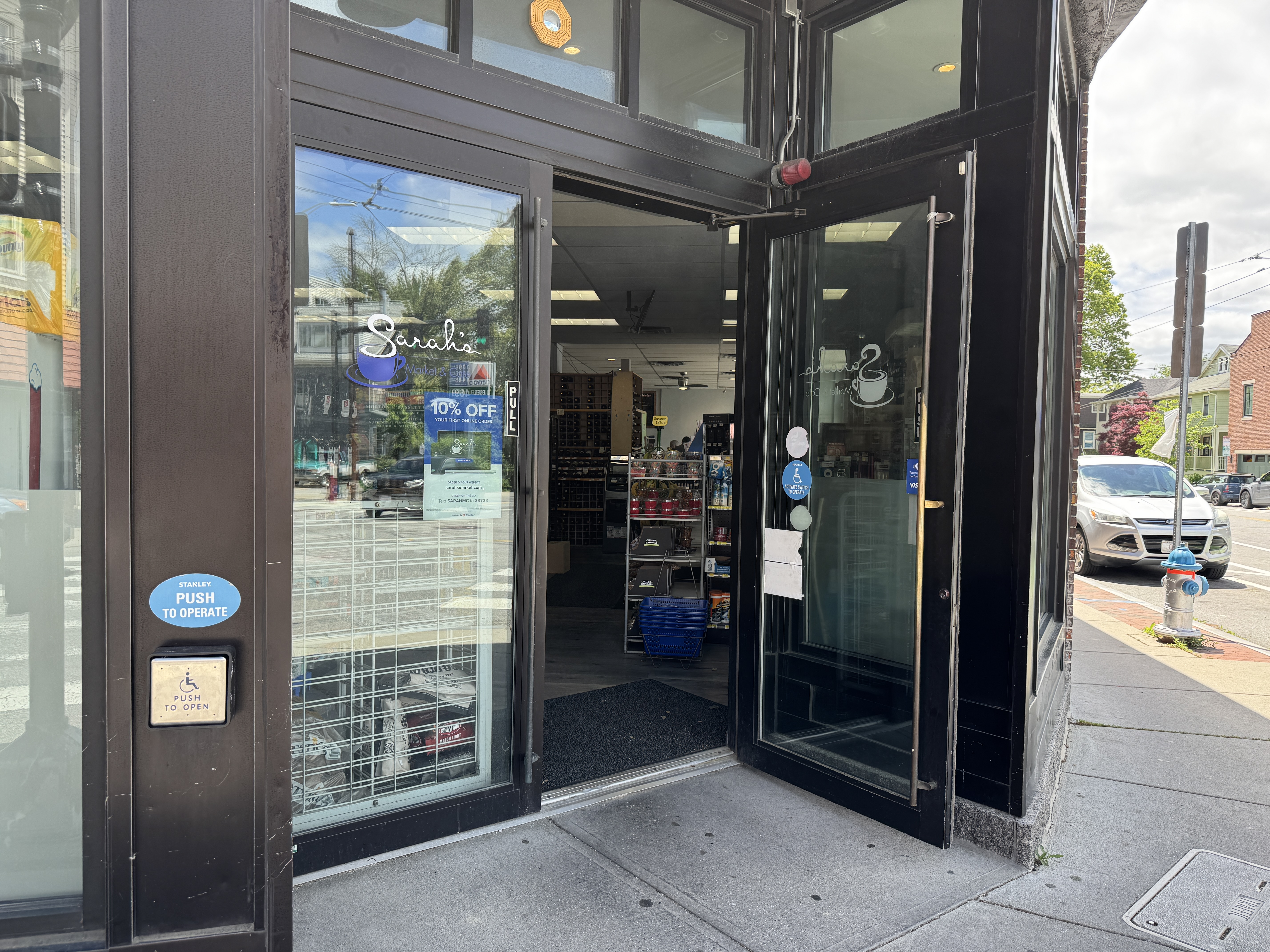 A photo of Sarah's Market cafe entrance, showing an ADA push button.