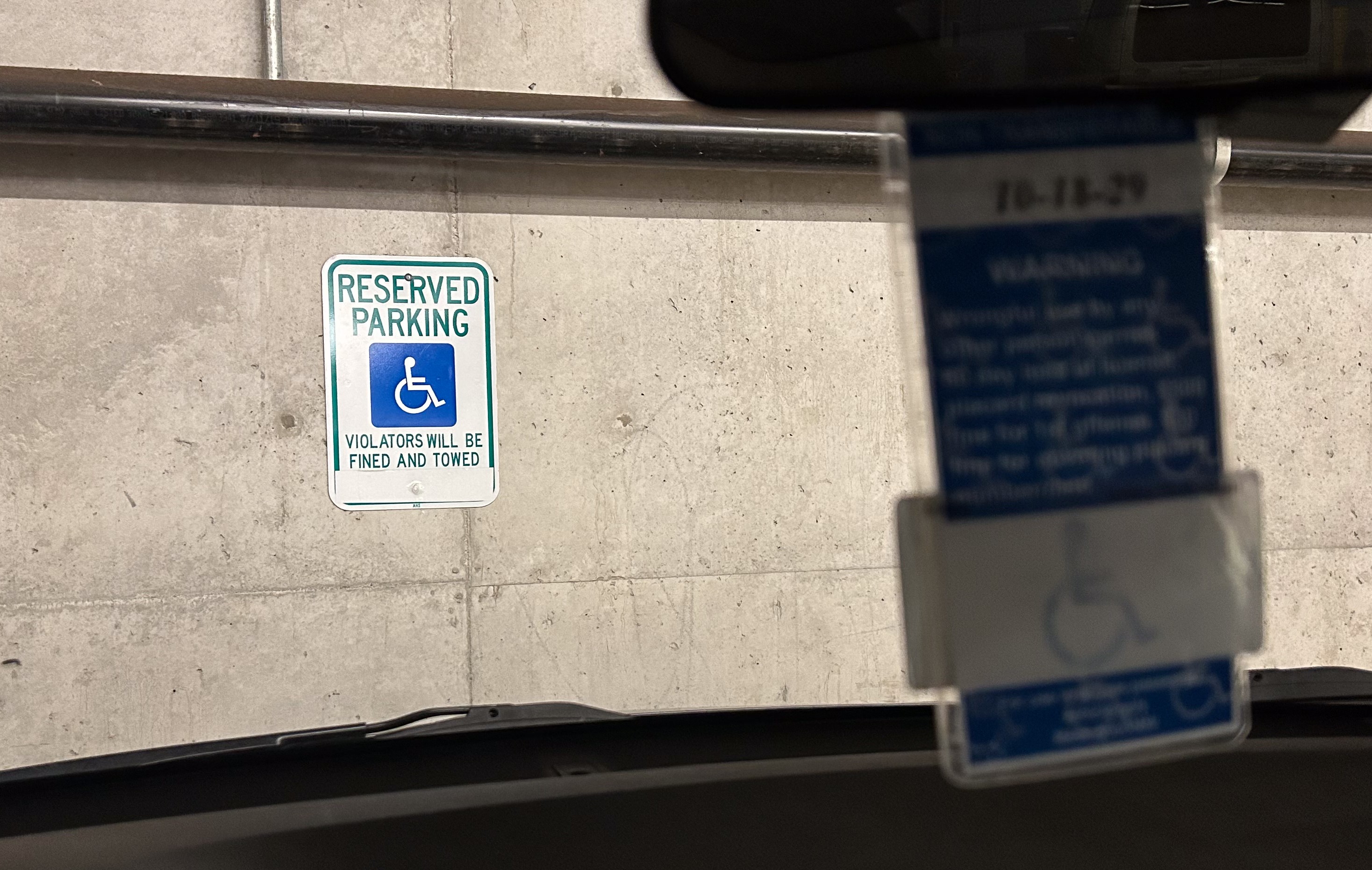 A close up of a disability placard in a car