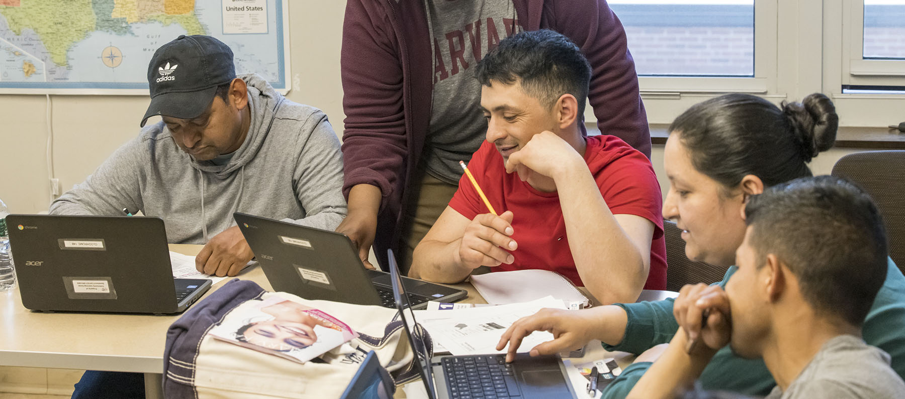 Adult learners take notes from their computer screens