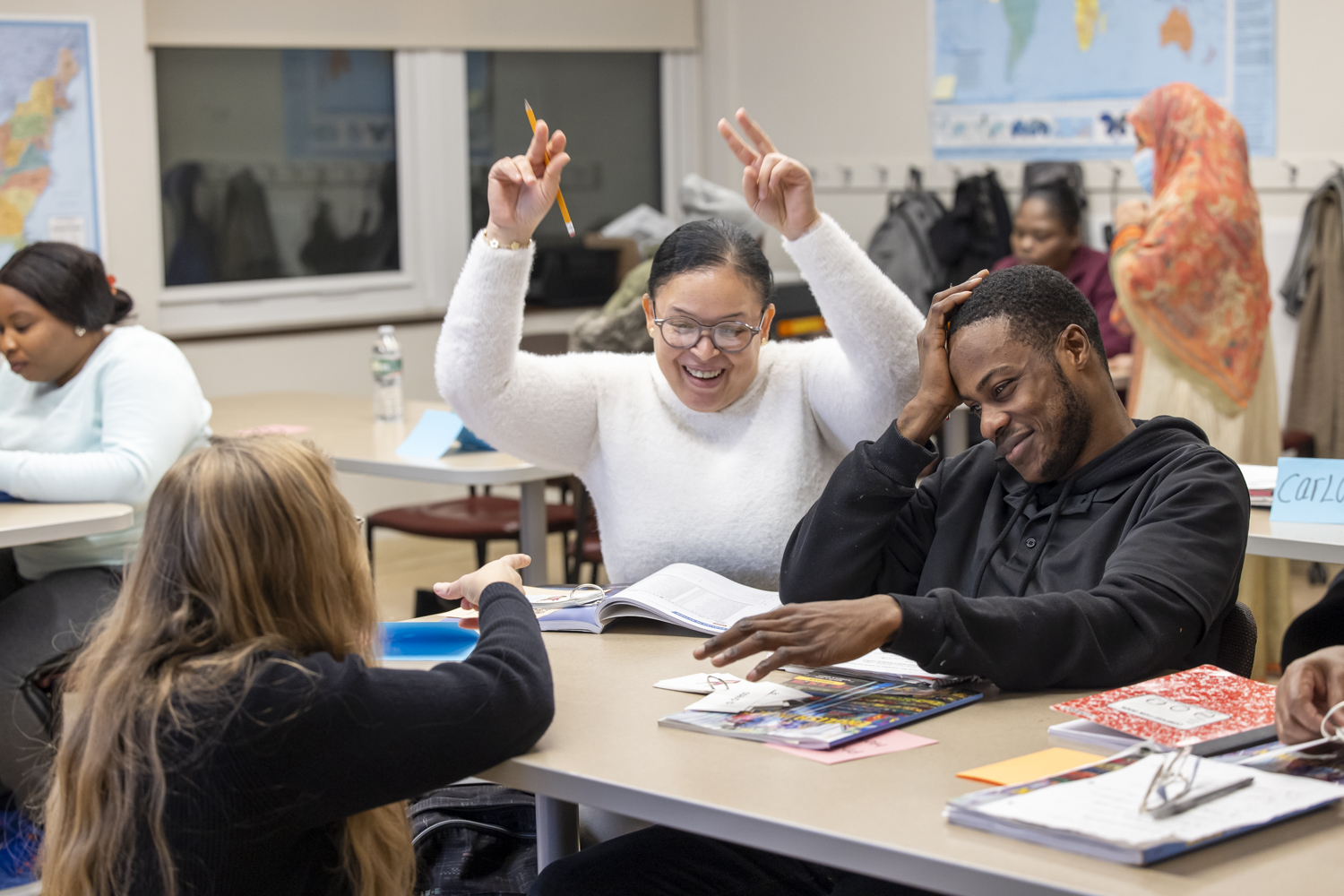 Two students celebrate while working on a worksheet