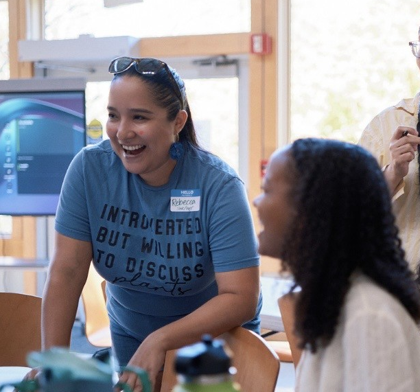 Green Jobs Specialist, wearing blue, advises residents