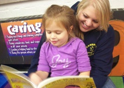 Afterschool Staff member reading to child