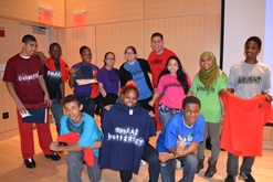 Youth holding shirts after a youth center production