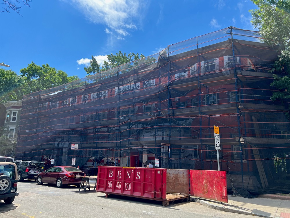 Park View, a limited equity housing cooperative, starting to undergo construction. The originally-red building is covered in scaffolding.