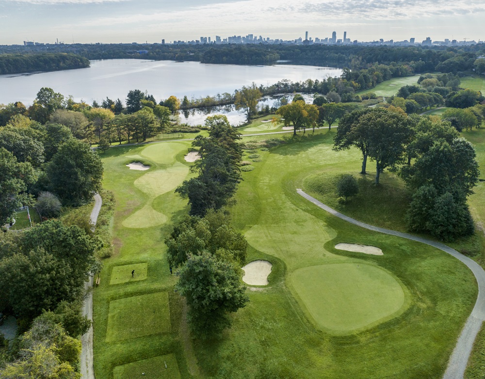 An aerial view of the golf course fairways, teeing areas, bunkers, and Fresh Pond.