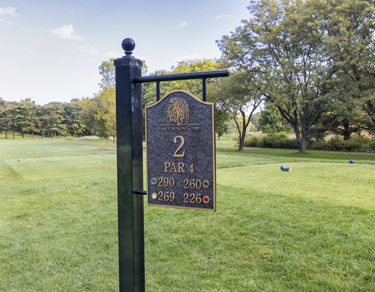 A sign on the green marking Hole 2.
