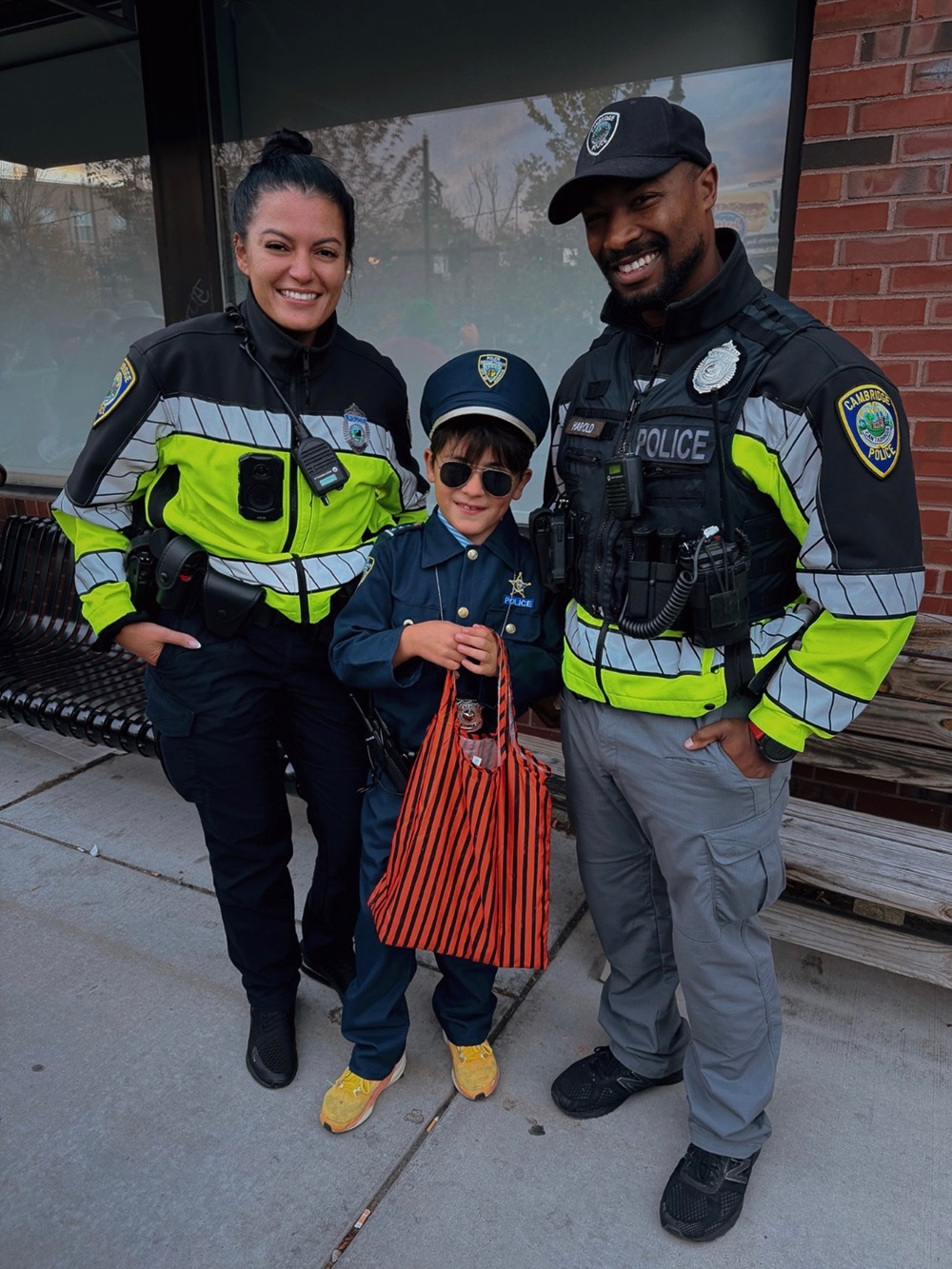 Cambridge Police Officers celebrate Halloween with a young resident.