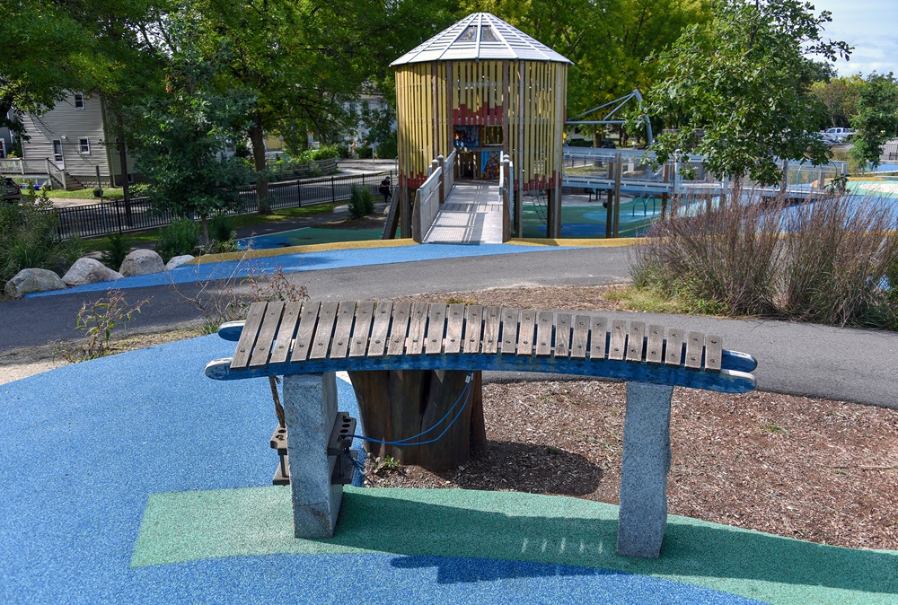 A play structure at Universal Design Playground offers a fun and accessible climbing surface for young residents.