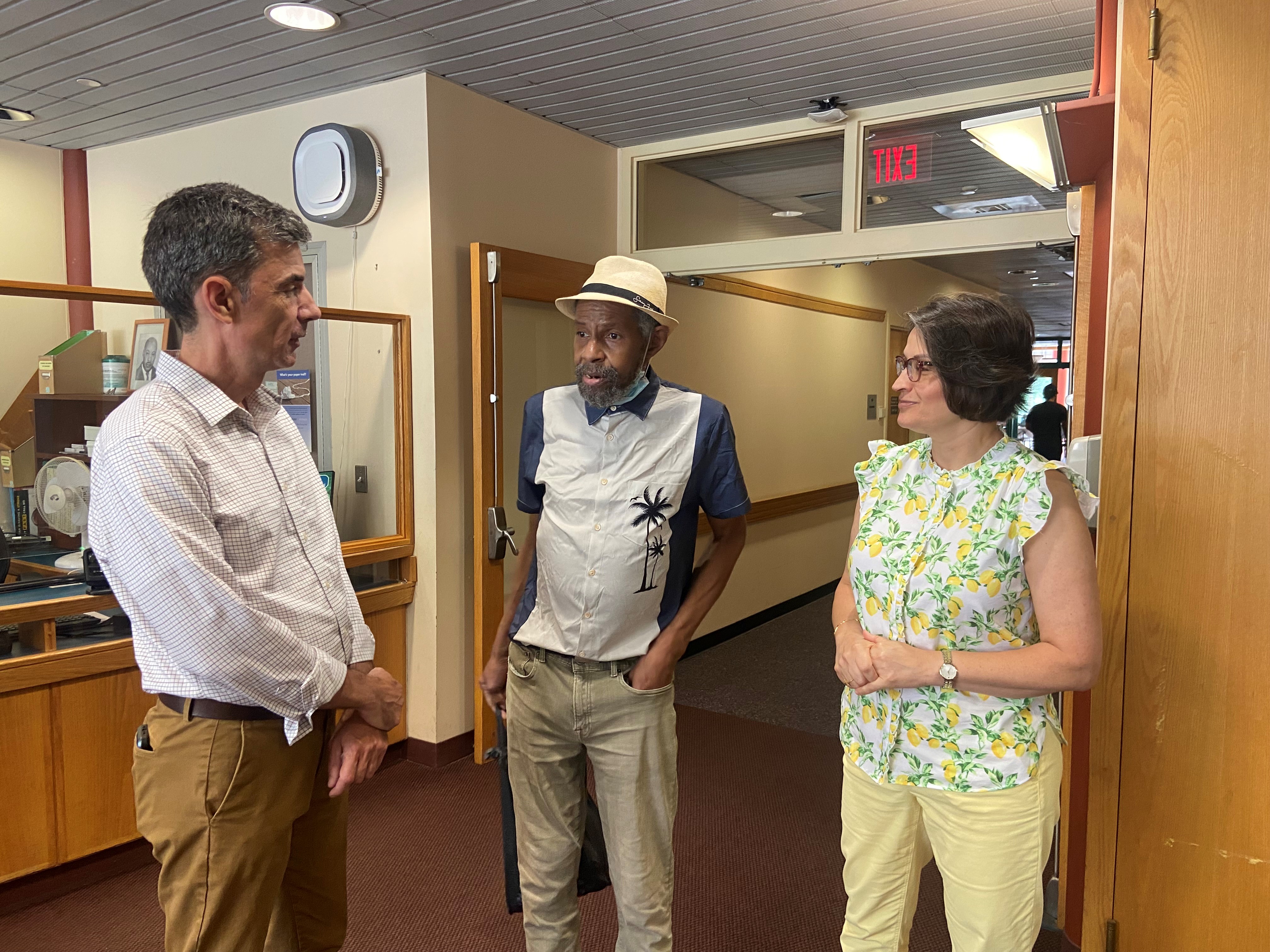 City Staff Support Provide Critical Support to Vulnerable Residents. Council on Aging Executive Director Susan Pacheco (right) and Director of Client Services Vincent McCarthy (left) greet a client of the Citywide Senior Center.