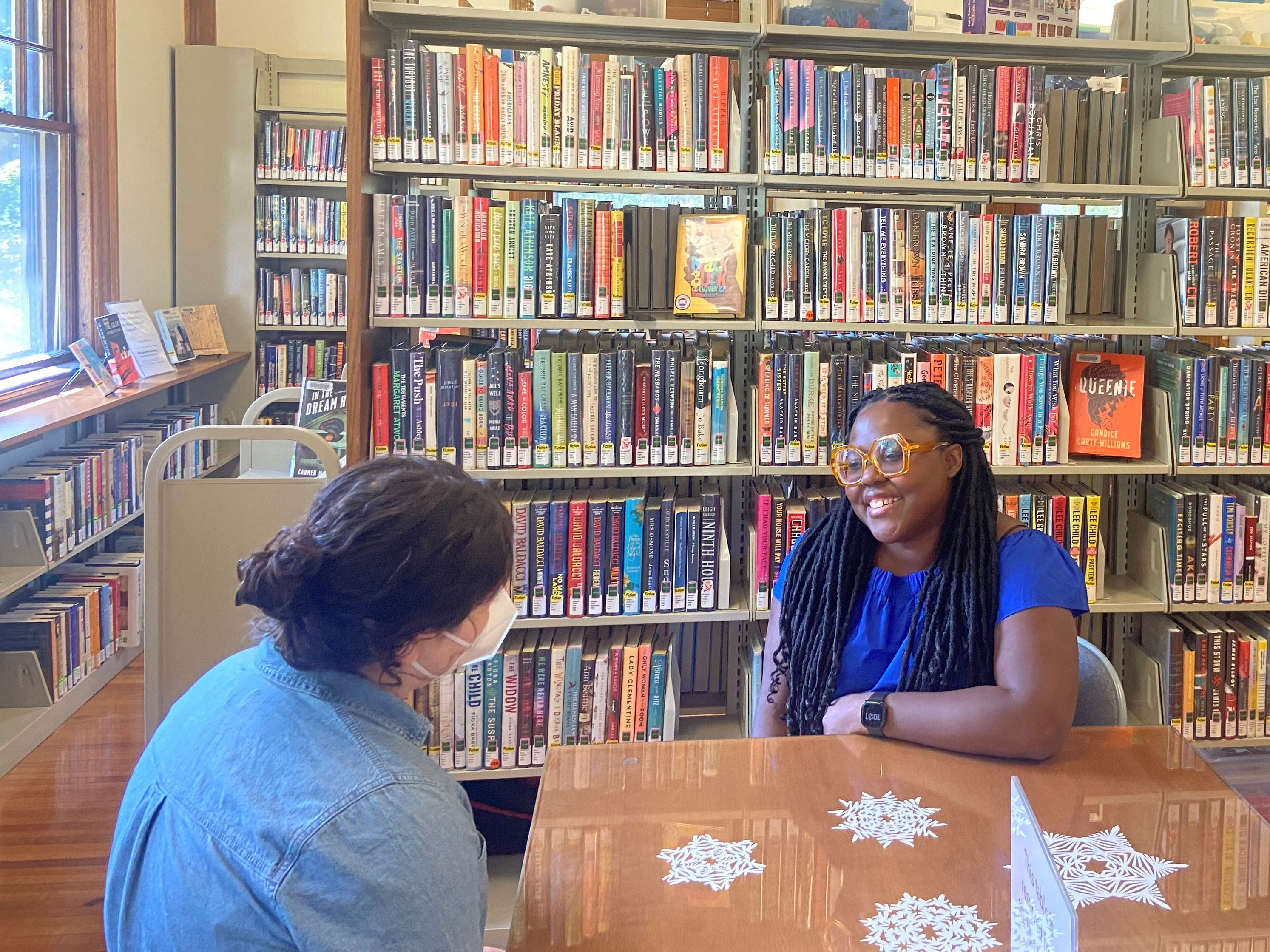 Library Social Worker Marie Mathieu meets with a client at a neighborhood library branch.