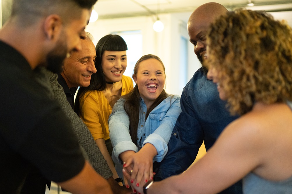 iStock photo of a group of people putting their hands together depicting Equity and Inclusion
