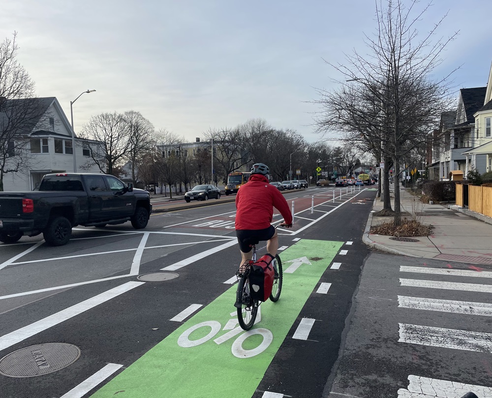 A cyclist in a separated bike lane along Massachusetts Avenue.