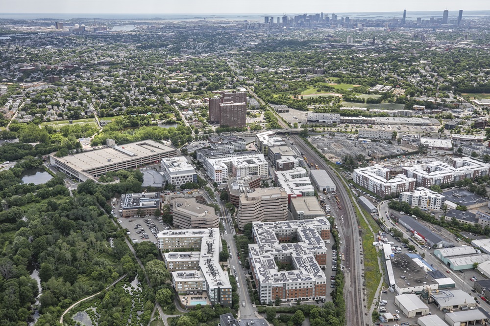 Aerial view of Alewife in Cambridge, MA with residential and commercial buildings, intersected by a highway.