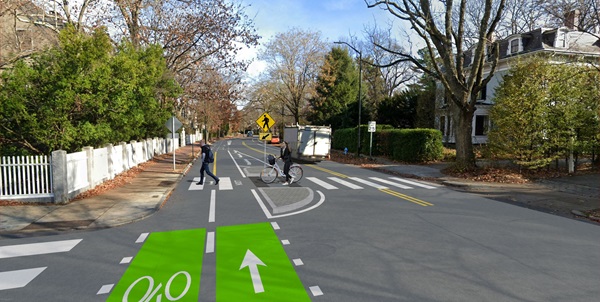 Image shows a rendering of a pedestrian crossing island in between the two-way bike lane and vehicle travel lanes.