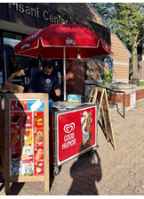 Man behind red ice cream cart