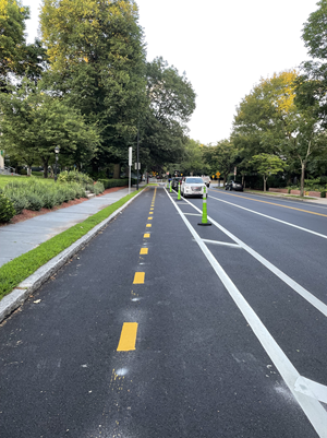 The new two-way bike lane on Brattle Street is currently separated from traffic by temporary cones. In the coming weeks, we'll add concrete barriers and flex posts.