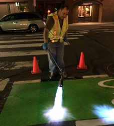 Photo of City Staff Painting Bike Lane on a City Street