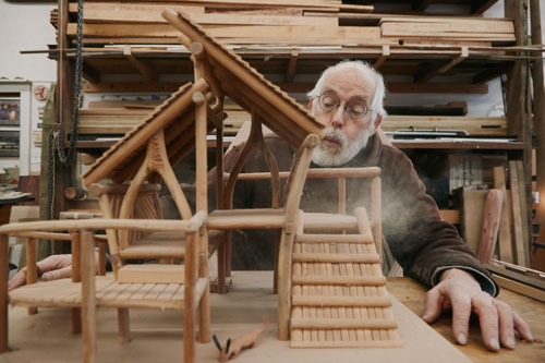 Mitch Ryerson with a playground model in his studio. ("Dust" by Mei Tao, 2024.)